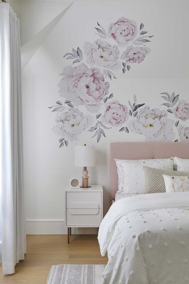 children's bedroom with floral wallpaper and light pink upholstery